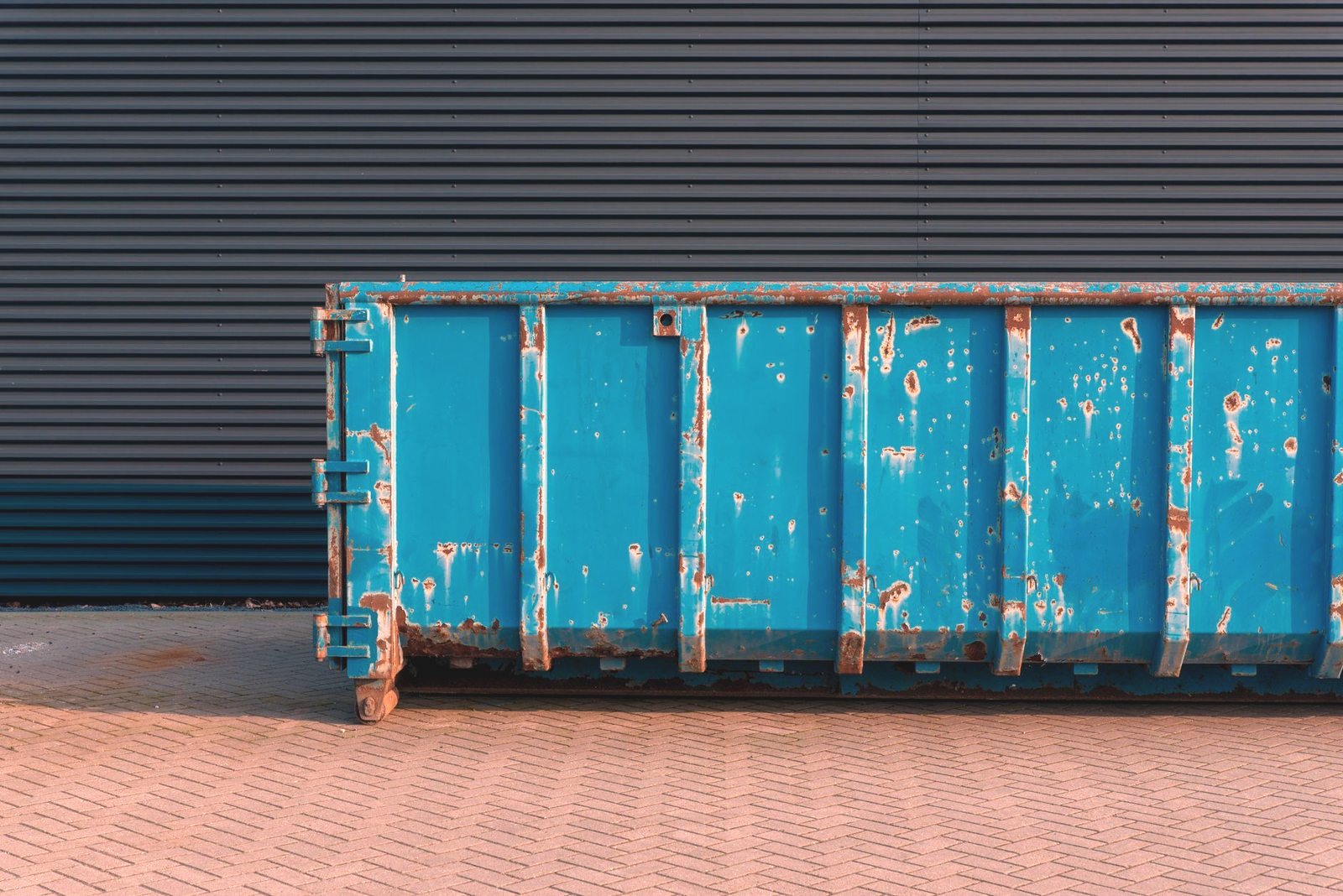 Debris being loaded into a roll-off dumpster
